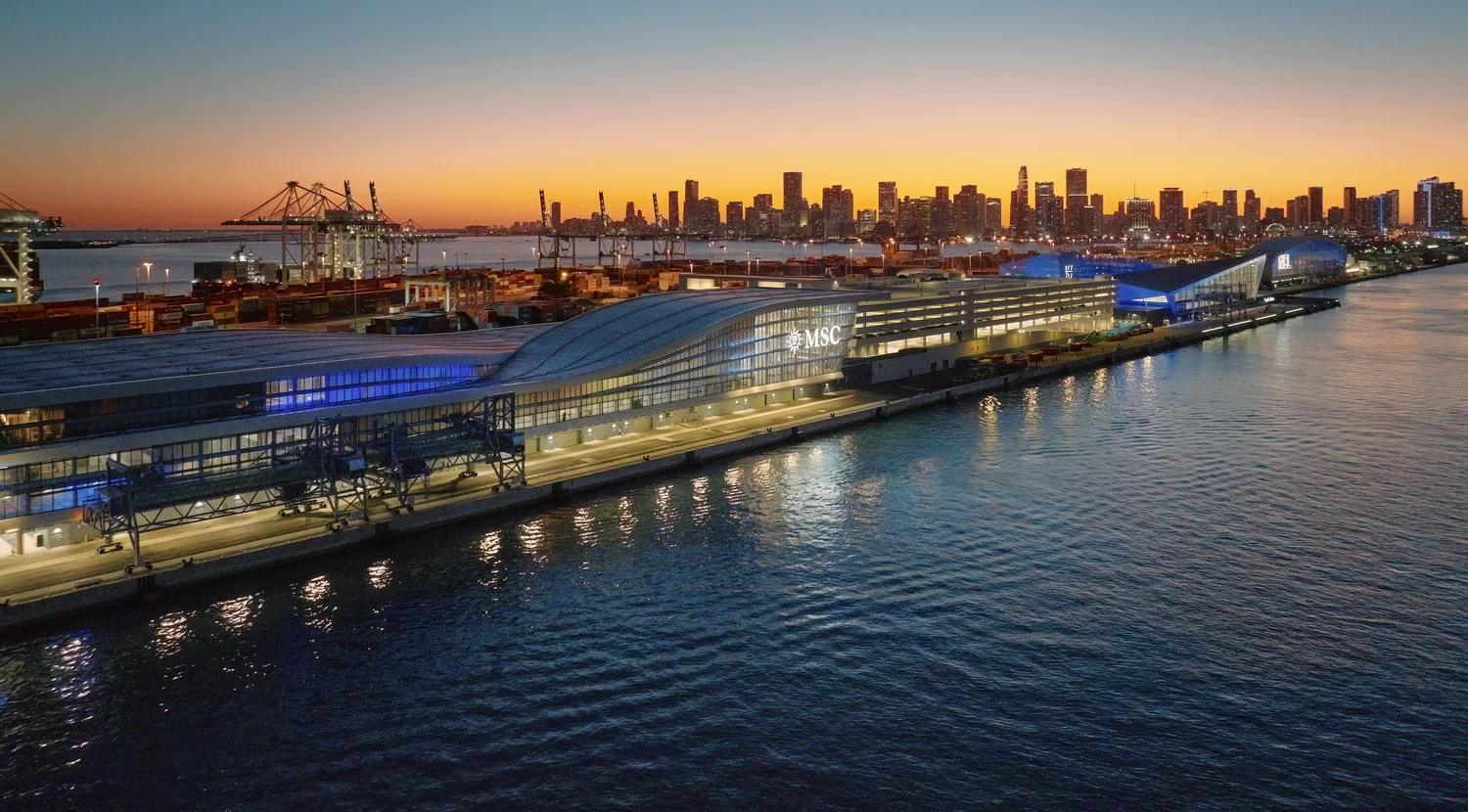 Cruise ships docked at PortMiami with the Miami skyline and turquoise water